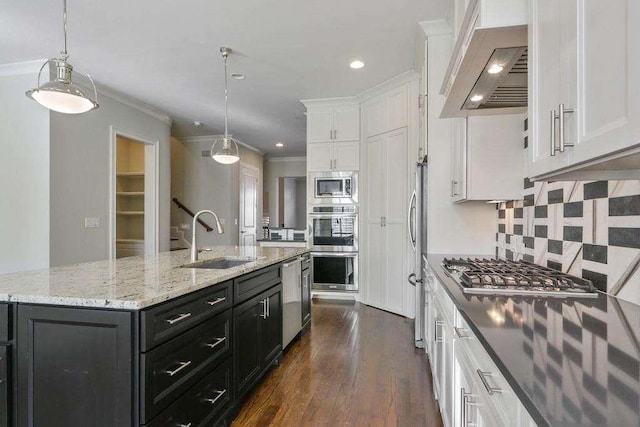 1117 Cordia Ave, Atlanta, GA 30318 - kitchen featuring custom range hood, appliances with stainless steel finishes, white cabinetry, dark cabinetry, and ornamental molding