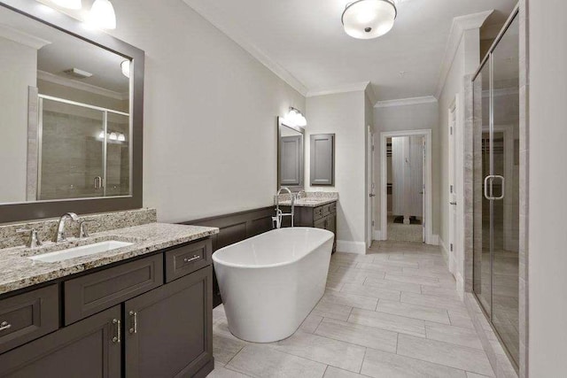 1117 Cordia Ave, Atlanta, GA 30318 - bathroom with a stall shower, crown molding, two vanities, and a freestanding bath