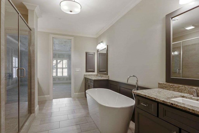 1117 Cordia Ave, Atlanta, GA 30318 - bathroom featuring a shower stall, ornamental molding, a freestanding bath, two vanities, and tile patterned flooring
