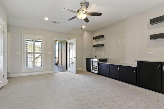 1117 Cordia Ave, Atlanta, GA 30318 - kitchen featuring dark cabinets, open shelves, a ceiling fan, light colored carpet, and light countertops