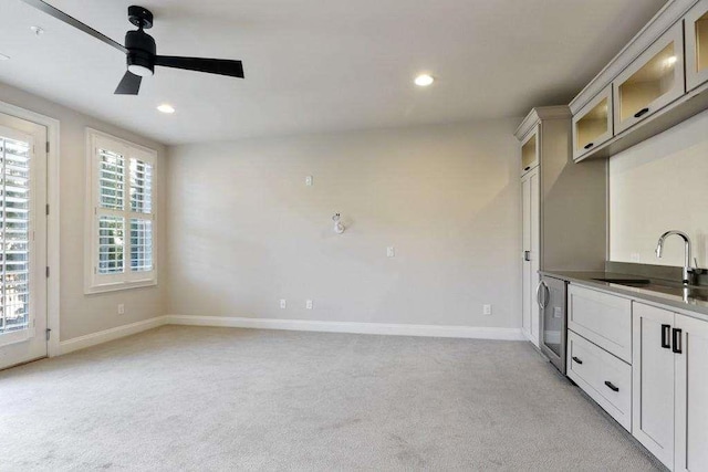 1117 Cordia Ave, Atlanta, GA 30318 - kitchen featuring light carpet, ceiling fan, glass insert cabinets, recessed lighting, and white cabinetry