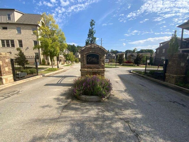 1117 Cordia Ave, Atlanta, GA 30318 - view of asphalt road featuring curbs, a gate, and a residential view
