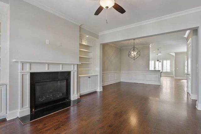 1117 Cordia Ave, Atlanta, GA 30318 - unfurnished living room featuring a ceiling fan, ornamental molding, built in features, a glass covered fireplace, and dark wood-type flooring