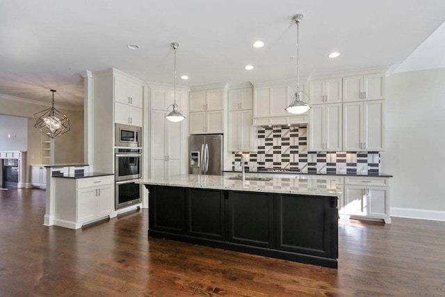 1117 Cordia Ave, Atlanta, GA 30318 - kitchen with appliances with stainless steel finishes, backsplash, white cabinets, dark wood-style flooring, and recessed lighting