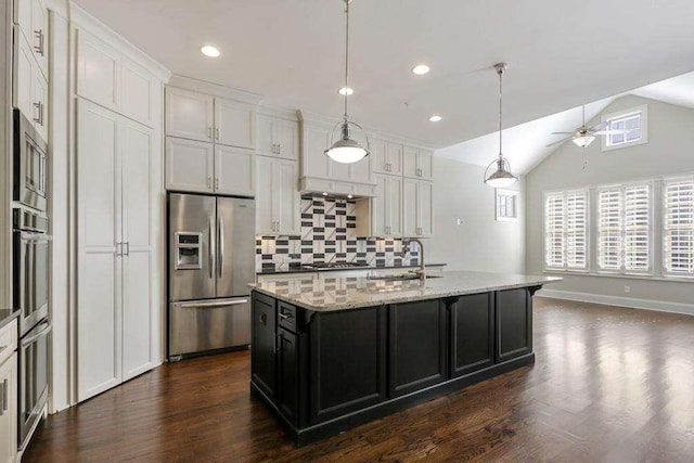 1117 Cordia Ave, Atlanta, GA 30318 - kitchen featuring stainless steel appliances, backsplash, a ceiling fan, dark wood finished floors, and a kitchen island with sink