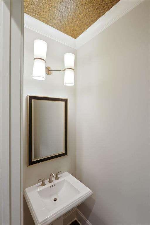 1117 Cordia Ave, Atlanta, GA 30318 - bathroom featuring crown molding and a sink