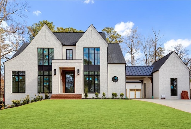 view of front of house with a garage and a front yard