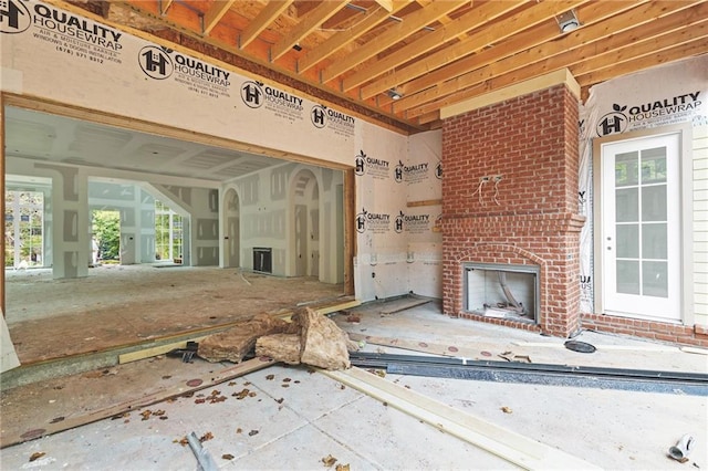 miscellaneous room with a brick fireplace