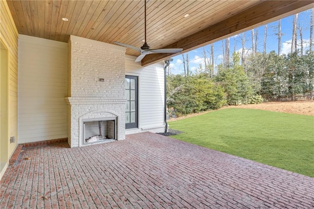 view of patio featuring an outdoor brick fireplace and ceiling fan