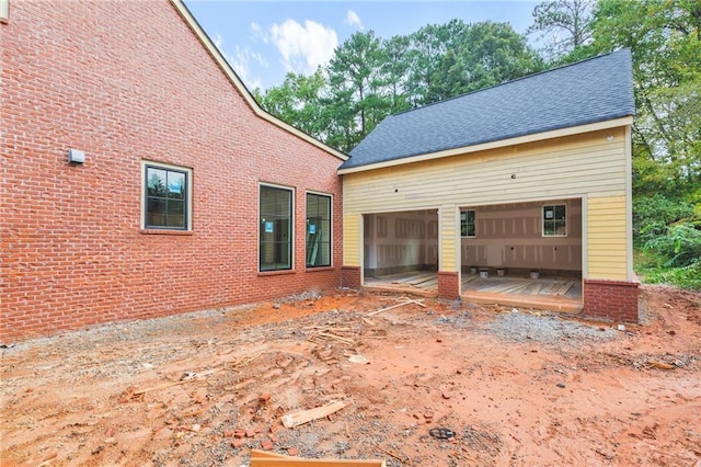 rear view of house with a garage