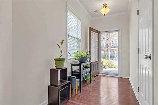 entryway featuring visible vents, crown molding, baseboards, and hardwood / wood-style floors