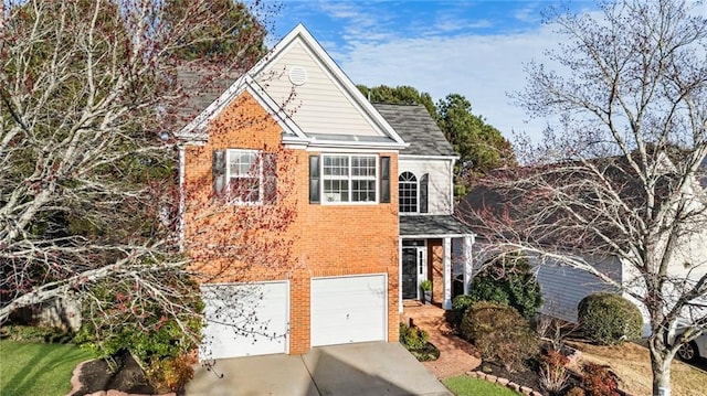 traditional-style home with an attached garage, concrete driveway, and brick siding