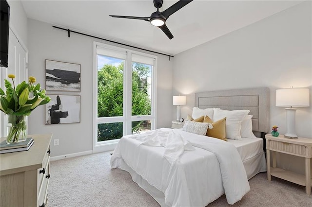 bedroom with ceiling fan and light colored carpet