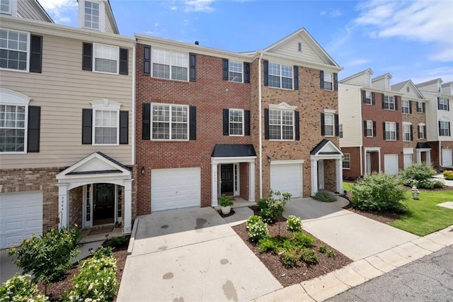 3542 Chattahoochee Summit Ln SE, Atlanta, GA 30339 - townhome / multi-family property with brick siding, driveway, and an attached garage