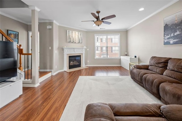 3542 Chattahoochee Summit Ln SE, Atlanta, GA 30339 - living area with a ceiling fan, wood finished floors, recessed lighting, crown molding, and a glass covered fireplace