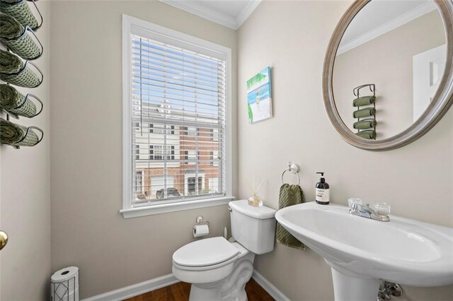 3542 Chattahoochee Summit Ln SE, Atlanta, GA 30339 - half bathroom featuring crown molding, wood finished floors, baseboards, toilet, and a sink