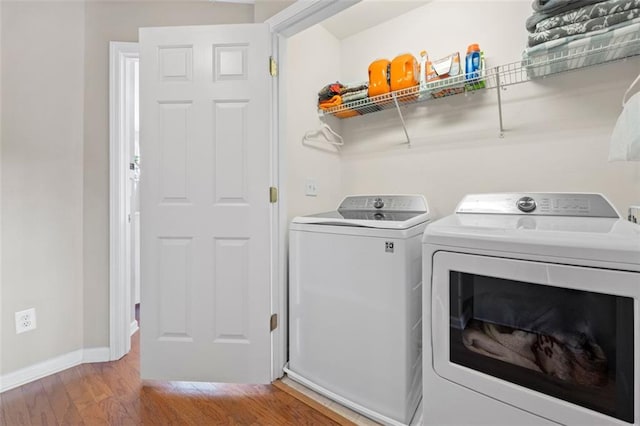 3542 Chattahoochee Summit Ln SE, Atlanta, GA 30339 - laundry area with washing machine and clothes dryer, light wood-type flooring, and baseboards