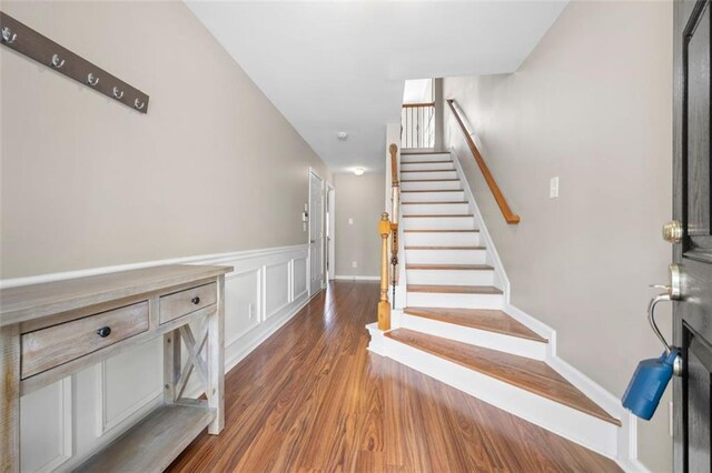 3542 Chattahoochee Summit Ln SE, Atlanta, GA 30339 - stairway featuring wood finished floors and wainscoting