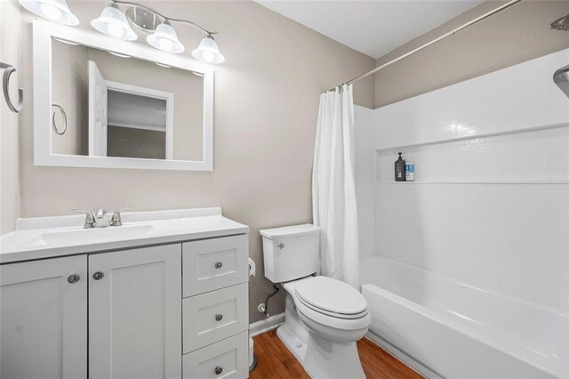 3542 Chattahoochee Summit Ln SE, Atlanta, GA 30339 - bathroom featuring wood finished floors, toilet, vanity, and shower / bathtub combination with curtain