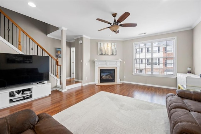 3542 Chattahoochee Summit Ln SE, Atlanta, GA 30339 - living room with stairs, wood finished floors, ornamental molding, ceiling fan, and a fireplace with flush hearth