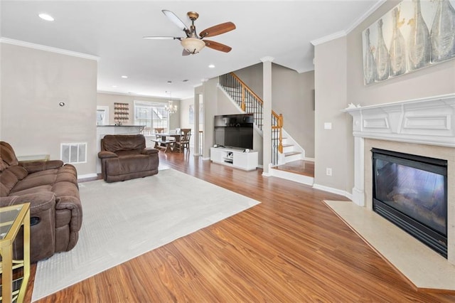 3542 Chattahoochee Summit Ln SE, Atlanta, GA 30339 - living room featuring stairway, a ceiling fan, a fireplace, wood finished floors, and baseboards