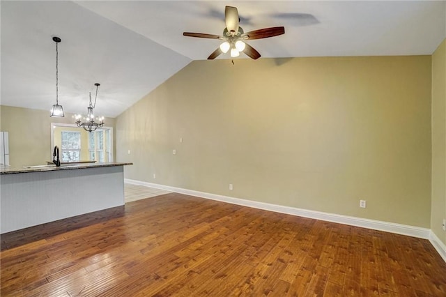 209 Jacobs Way, Jasper, GA 30143 - unfurnished living room with wood finished floors, ceiling fan, vaulted ceiling, and a chandelier