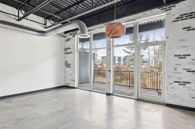 interior space with brick wall and concrete flooring