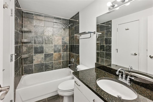 full bathroom with tiled shower / bath, vanity, and toilet