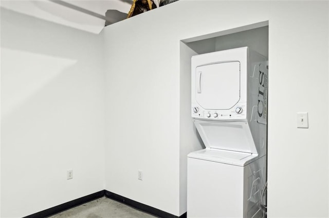 washroom featuring stacked washer / drying machine