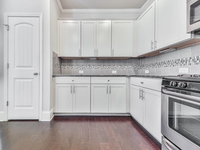 212 Torch Dr, Acworth, GA 30102 - kitchen featuring appliances with stainless steel finishes, crown molding, dark stone countertops, tasteful backsplash, and dark wood finished floors