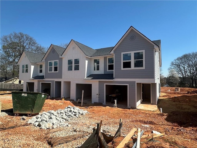 view of front of property with an attached garage, board and batten siding, and a shingled roof