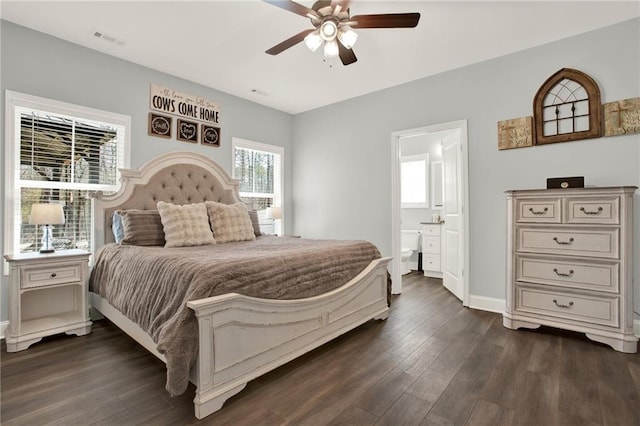 bedroom featuring dark wood-style flooring, visible vents, a ceiling fan, connected bathroom, and baseboards