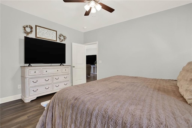 bedroom with ceiling fan, dark wood finished floors, and baseboards