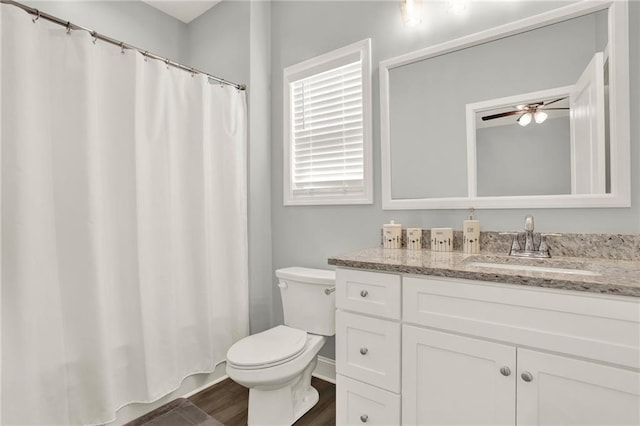 full bath featuring ceiling fan, vanity, toilet, and wood finished floors