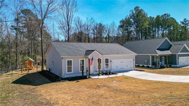 ranch-style home featuring a garage, driveway, a playground, and a front yard