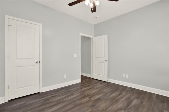 unfurnished bedroom featuring dark wood finished floors, baseboards, and ceiling fan