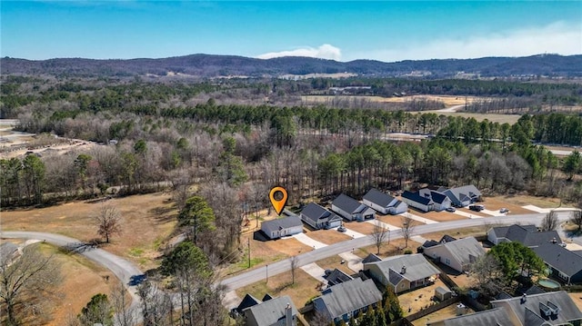 birds eye view of property with a forest view, a residential view, and a mountain view