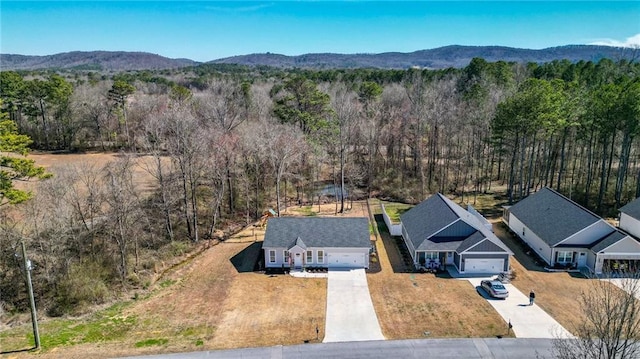 aerial view with a mountain view and a wooded view