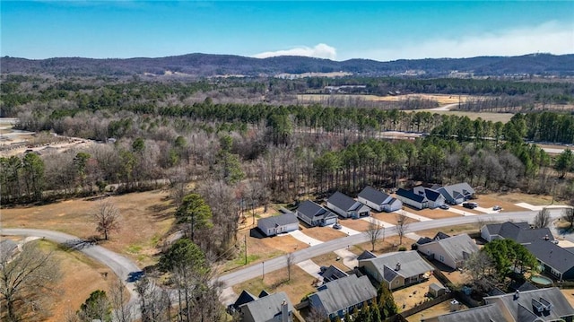 bird's eye view featuring a residential view, a mountain view, and a view of trees