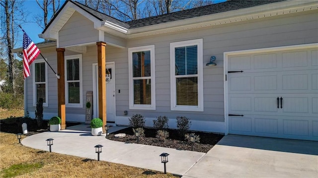 view of exterior entry featuring an attached garage