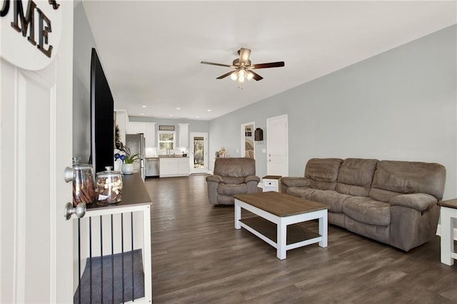 living room featuring recessed lighting, dark wood-style flooring, and ceiling fan