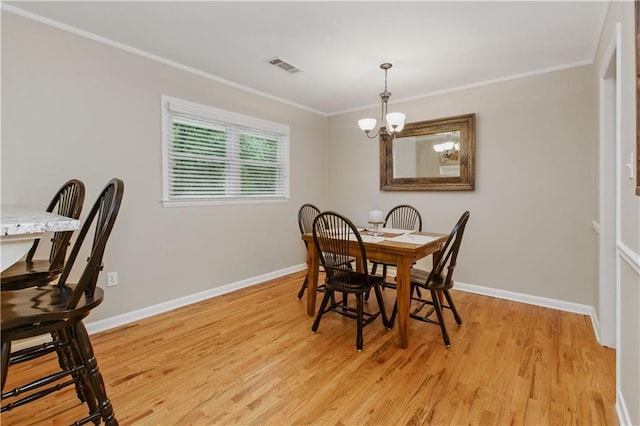 3110 Springdale Park Cir, Gainesville, GA 30506 - dining area with light wood finished floors, a chandelier, ornamental molding, and baseboards