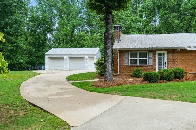 3110 Springdale Park Cir, Gainesville, GA 30506 - view of front of house with an outbuilding, brick siding, a front lawn, and a garage