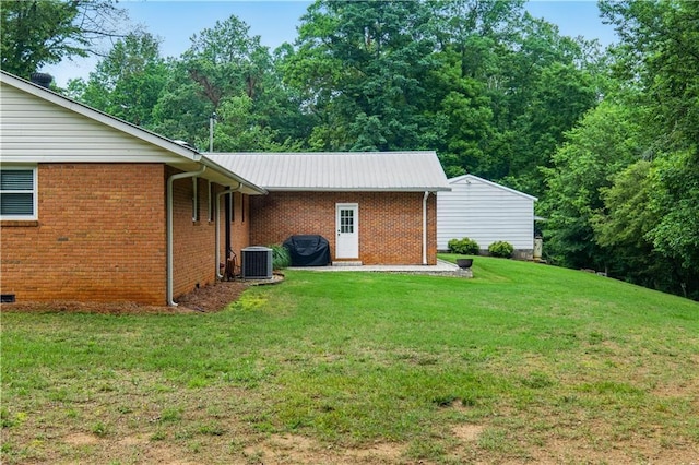 3110 Springdale Park Cir, Gainesville, GA 30506 - back of house featuring a lawn, brick siding, central AC, and metal roof