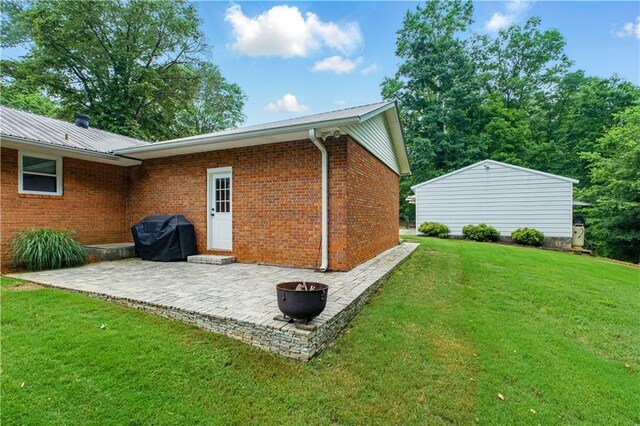 3110 Springdale Park Cir, Gainesville, GA 30506 - rear view of house with a patio area, a yard, a fire pit, and brick siding