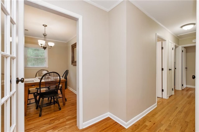 3110 Springdale Park Cir, Gainesville, GA 30506 - corridor featuring light wood-style flooring, a chandelier, ornamental molding, and baseboards
