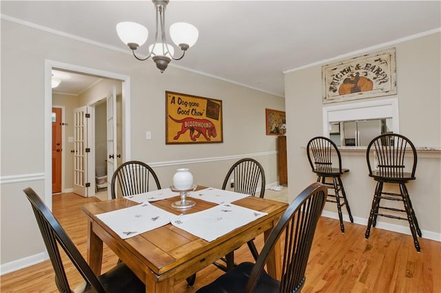 3110 Springdale Park Cir, Gainesville, GA 30506 - dining room featuring light wood-type flooring, a chandelier, crown molding, and baseboards