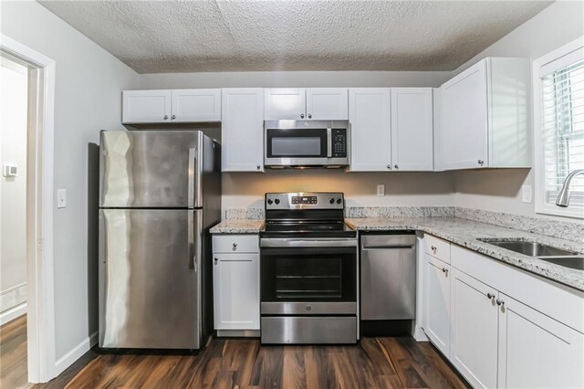 kitchen featuring white cabinetry, sink, and appliances with stainless steel finishes