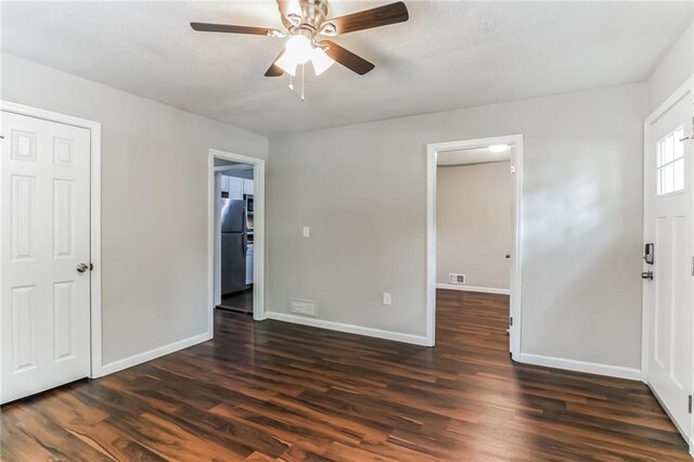 interior space featuring dark wood-type flooring and ceiling fan