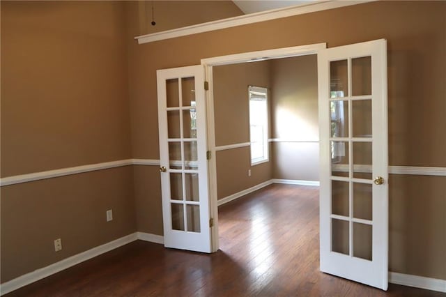 unfurnished room with french doors, baseboards, and wood finished floors